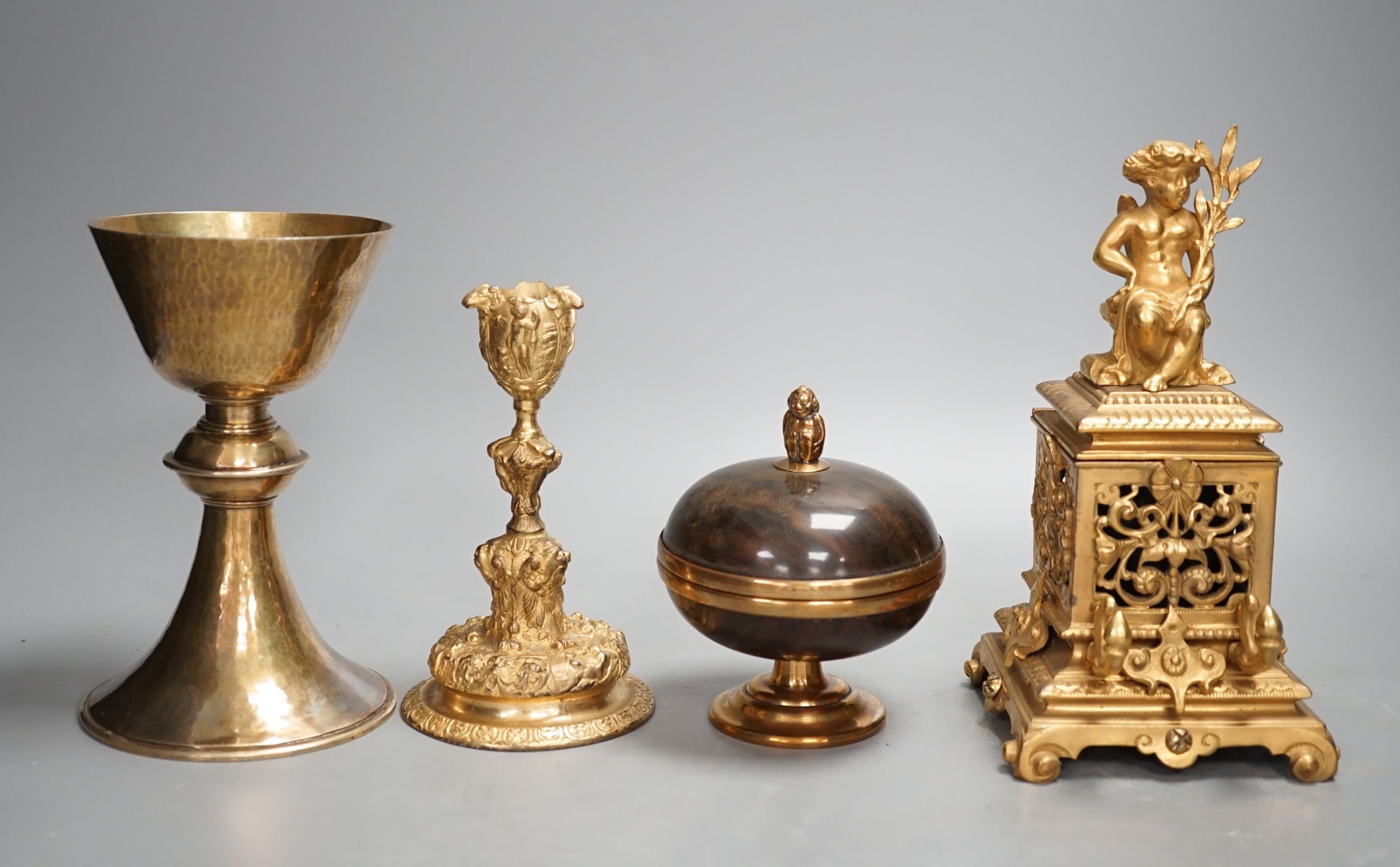 A decorative ormolu inkwell, 20cm high, a Baroque style candlestick, a chalice stamped W IV, together with a faux tortoiseshell pot (4)